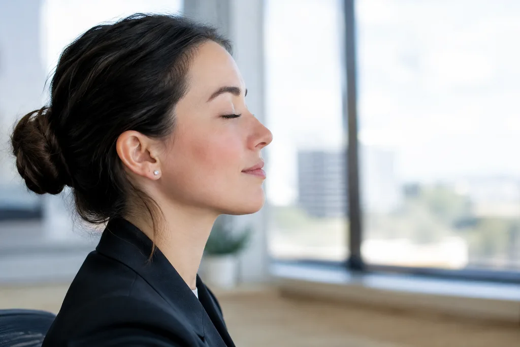Office worker closing their eyes for a deliberate blink break